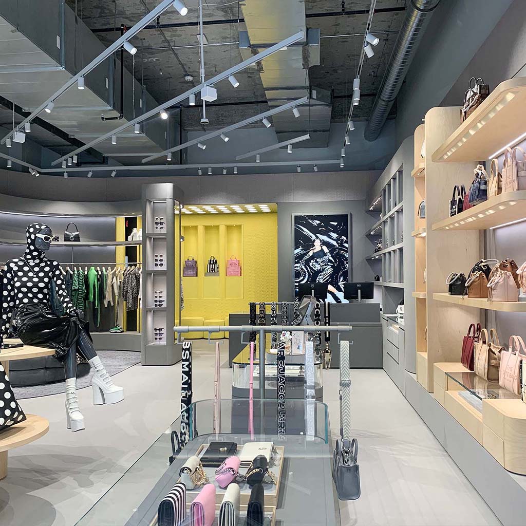 The interior of the Marc Jacobs store located in Miami Design District, USA. The retail design project was designed by Fantetti, that create the concept for the new Marc Jacobs stores. Key elements of the concept are the materials: yellow monogram quilted velvet, birch wood for the shelves, concrete and grey laquered furniture.